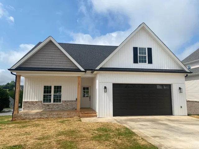 a front view of a house with garage and yard