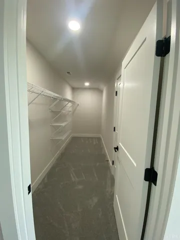 an empty room with windows and entrance