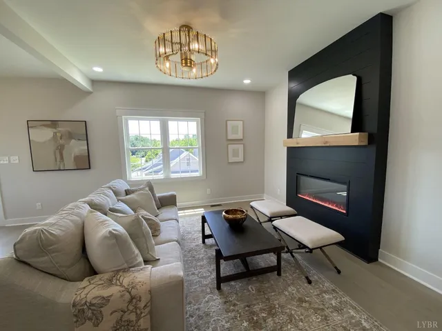 a living room with furniture a window and a fireplace