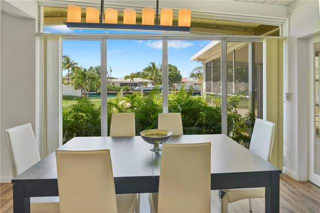a view of a patio with table and chairs and potted plants