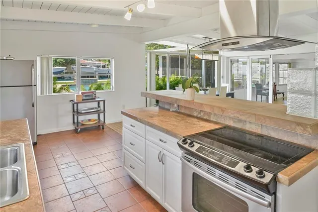 a kitchen with appliances cabinets and a table