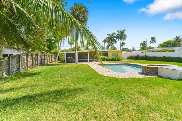 a view of a house with a yard and sitting area