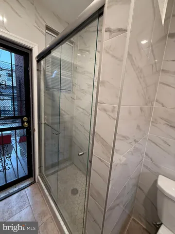 a bathroom with a shower and toilet