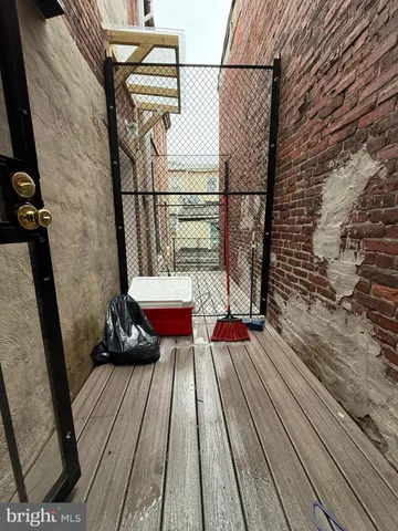 a view of balcony with wooden floor and outdoor seating