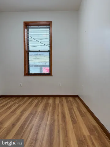 a view of a room with wooden floor and a window