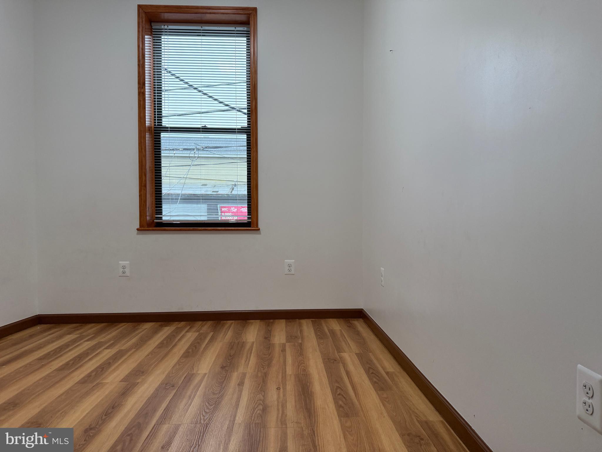 1017 Spring Garden Street, Unit 2F Philadelphia, PA 19123 - Photo 4 of 14 a view of a room with wooden floor and window