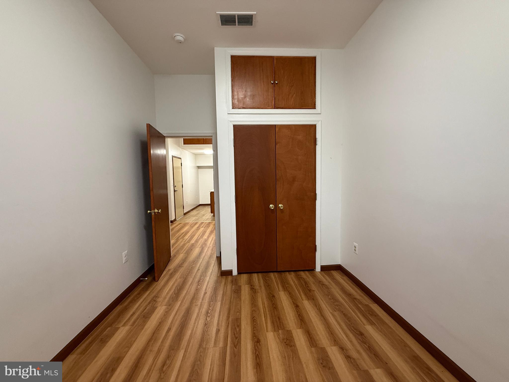 1017 Spring Garden Street, Unit 2F Philadelphia, PA 19123 - Photo 5 of 14 a view of a hallway with wooden floor and a bathroom