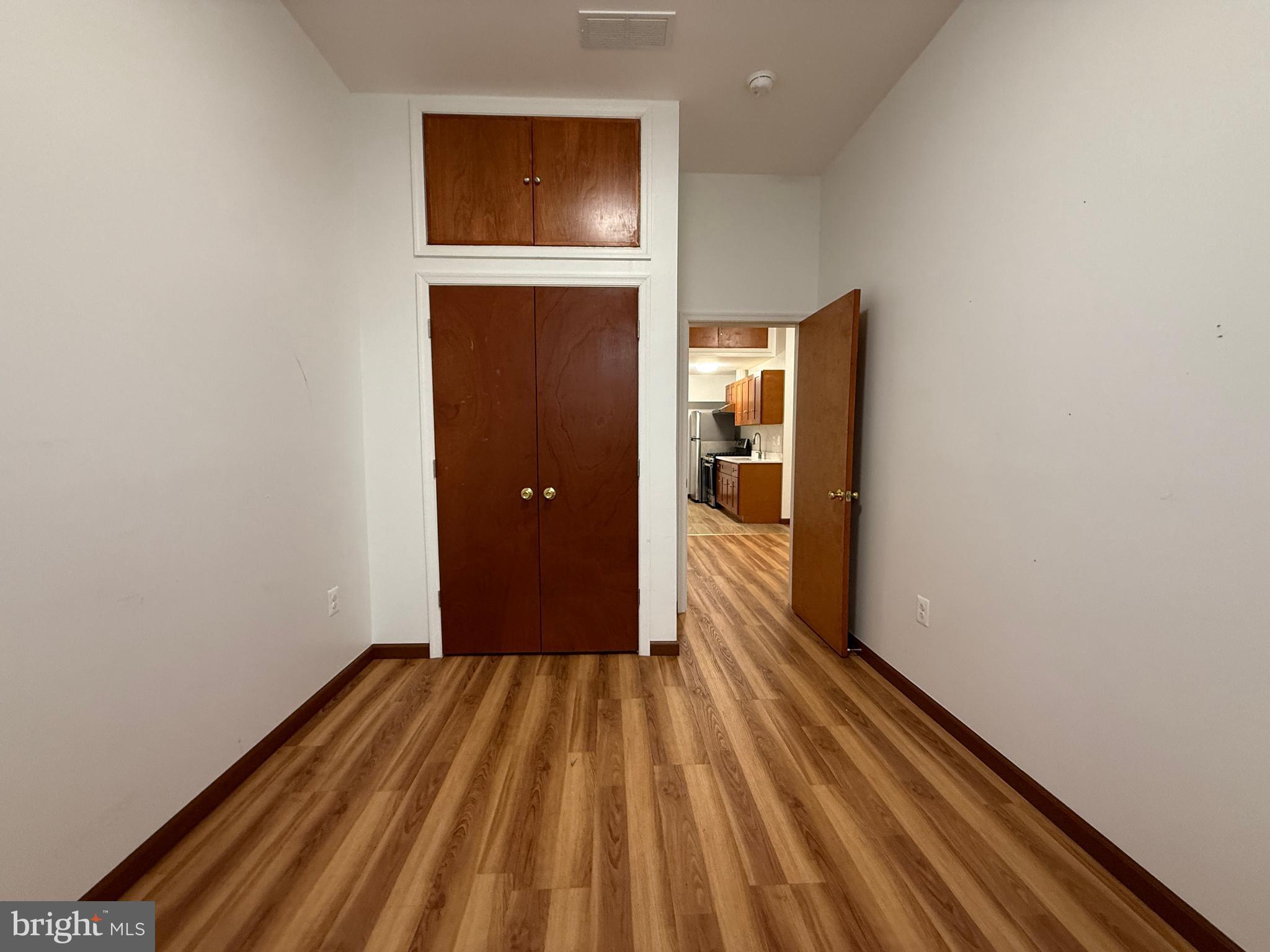 1017 Spring Garden Street, Unit 2F Philadelphia, PA 19123 - Photo 7 of 14 a view of a hallway with wooden floor and entryway