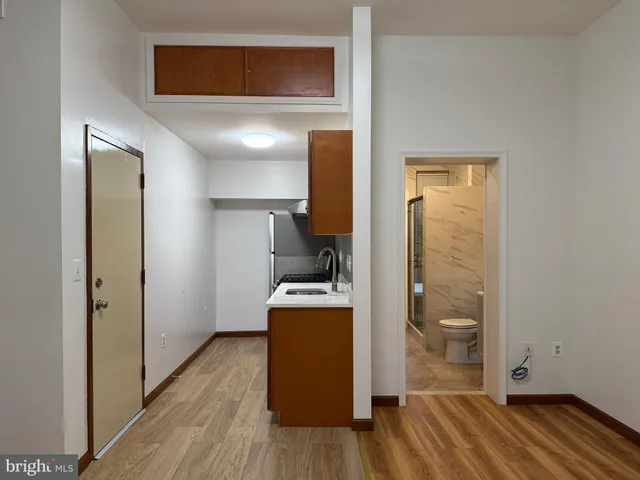 a view of a kitchen from a hallway