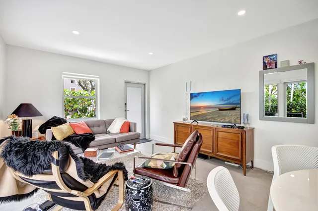 a kitchen with a sink a refrigerator a window and cabinets