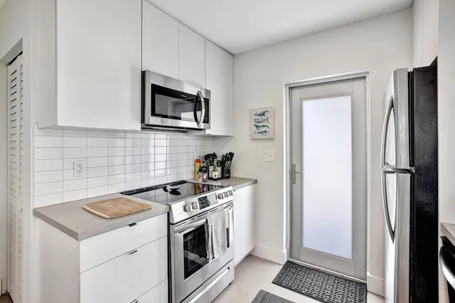 a view of backyard with swimming pool and seating area