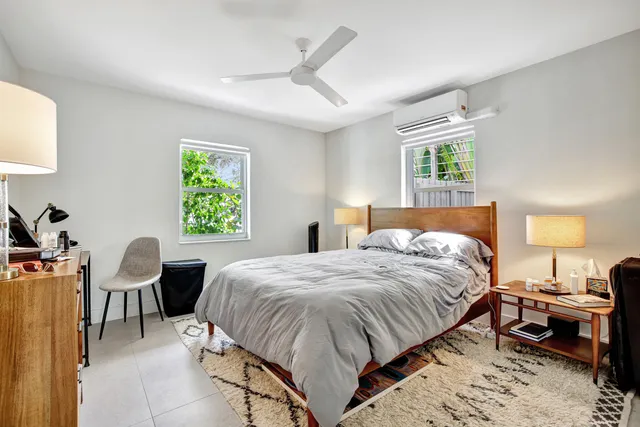 a dining room with furniture a rug and a large window