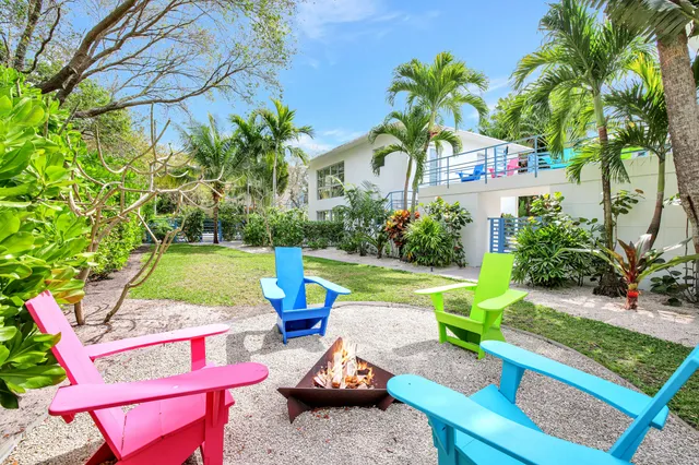 a living room with furniture a piano and a bookshelf