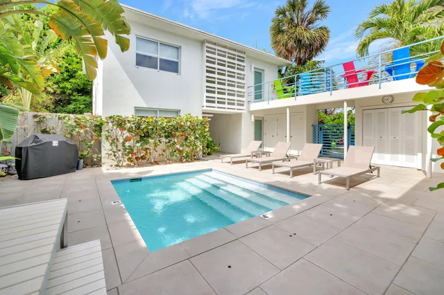 a view of a livingroom with furniture and a floor to ceiling window