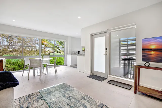 a bedroom with a bed a desk and chair with a bookshelf