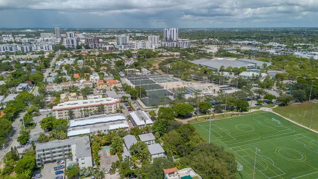 a living room with furniture kitchen view and a window