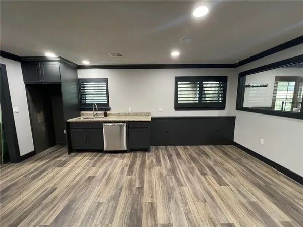 a view of an empty room and wooden floor