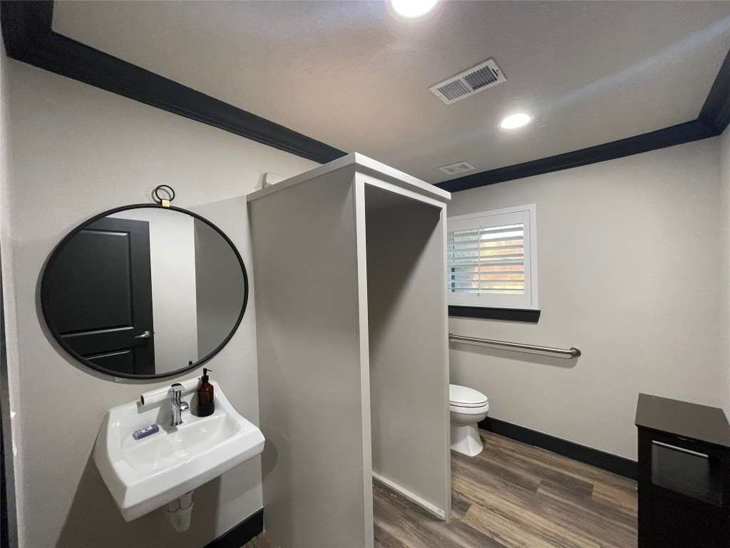 408 Wilson Road Conroe, TX 77301 - Photo 18 of 32 a bathroom with a toilet sink and mirror