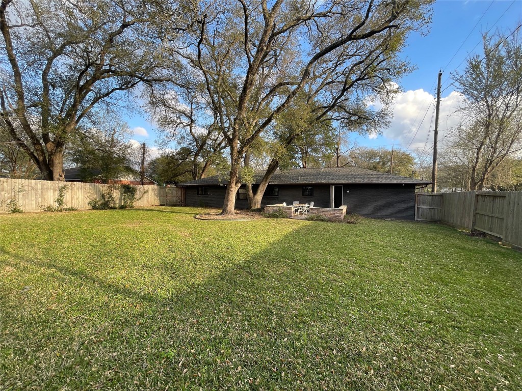 408 Wilson Road Conroe, TX 77301 - Photo 29 of 32 a view of a house with a yard