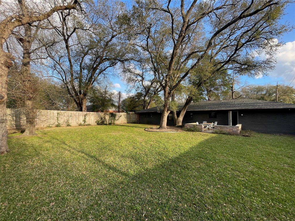 408 Wilson Road Conroe, TX 77301 - Photo 30 of 32 a view of a yard with a house and a large tree