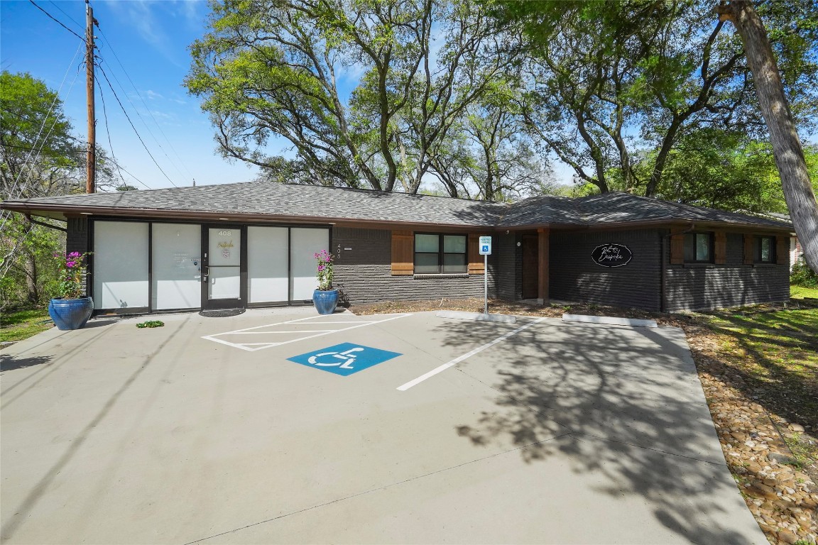 408 Wilson Road Conroe, TX 77301 - Photo 31 of 32 a front view of a house with a yard and garage