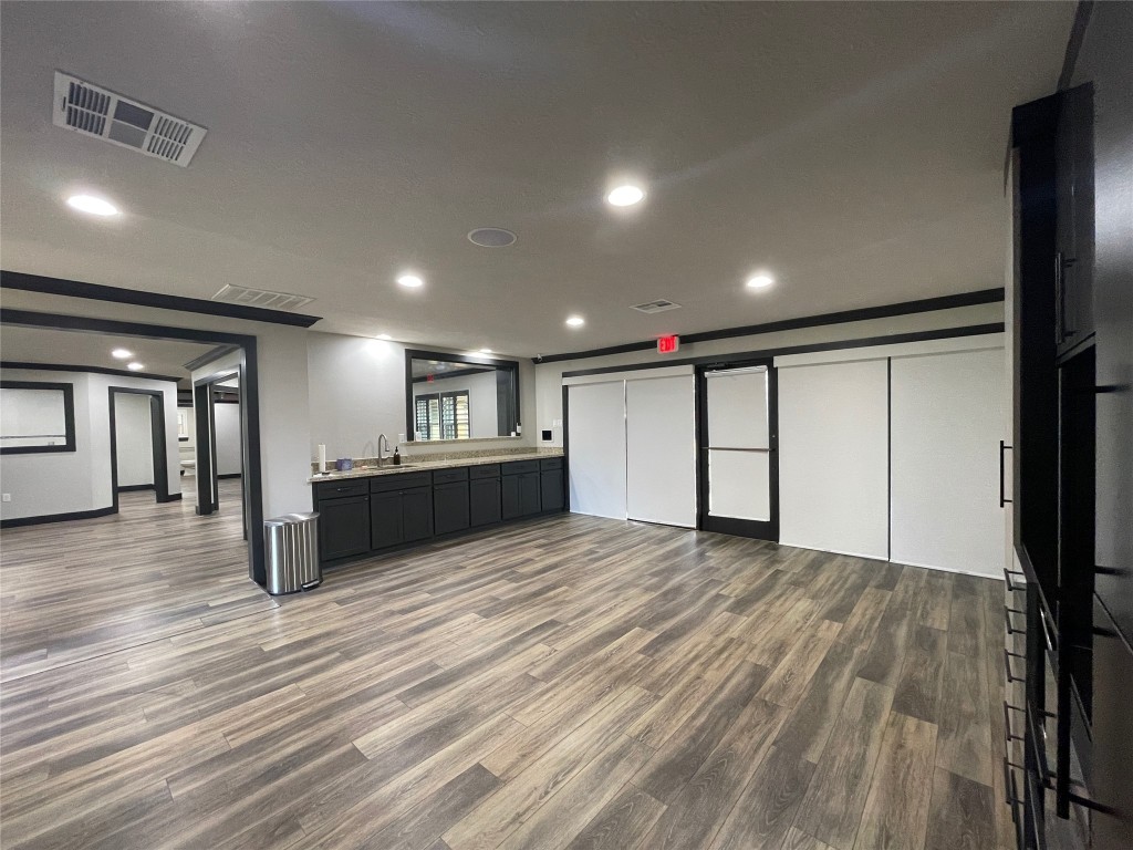 408 Wilson Road Conroe, TX 77301 - Photo 4 of 32 a view of an empty room with wooden floor and a window