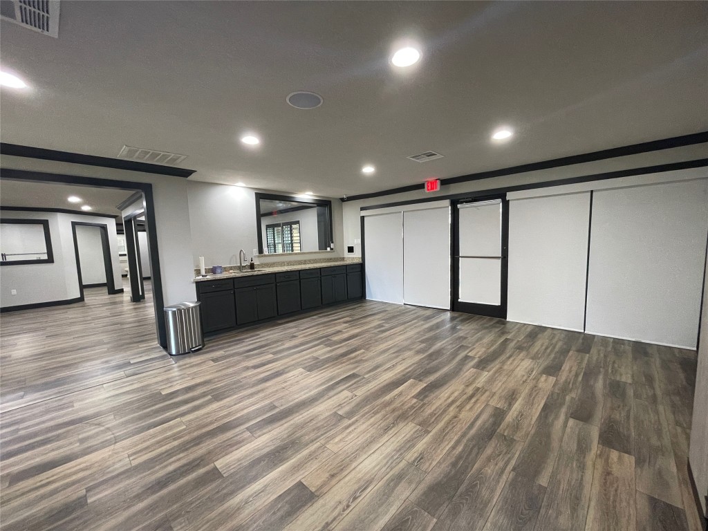408 Wilson Road Conroe, TX 77301 - Photo 5 of 32 a view of an empty room with wooden floor
