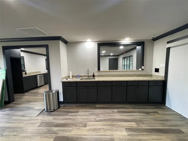 a view of a room with wooden floor