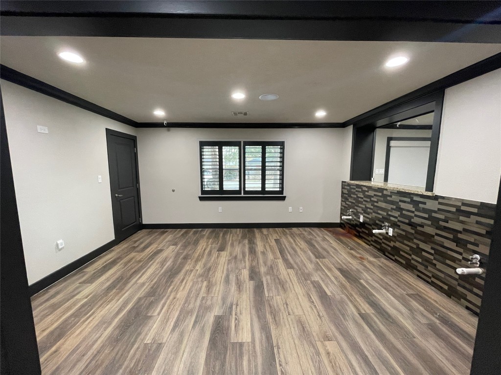 408 Wilson Road Conroe, TX 77301 - Photo 10 of 32 a view of a room with wooden floor
