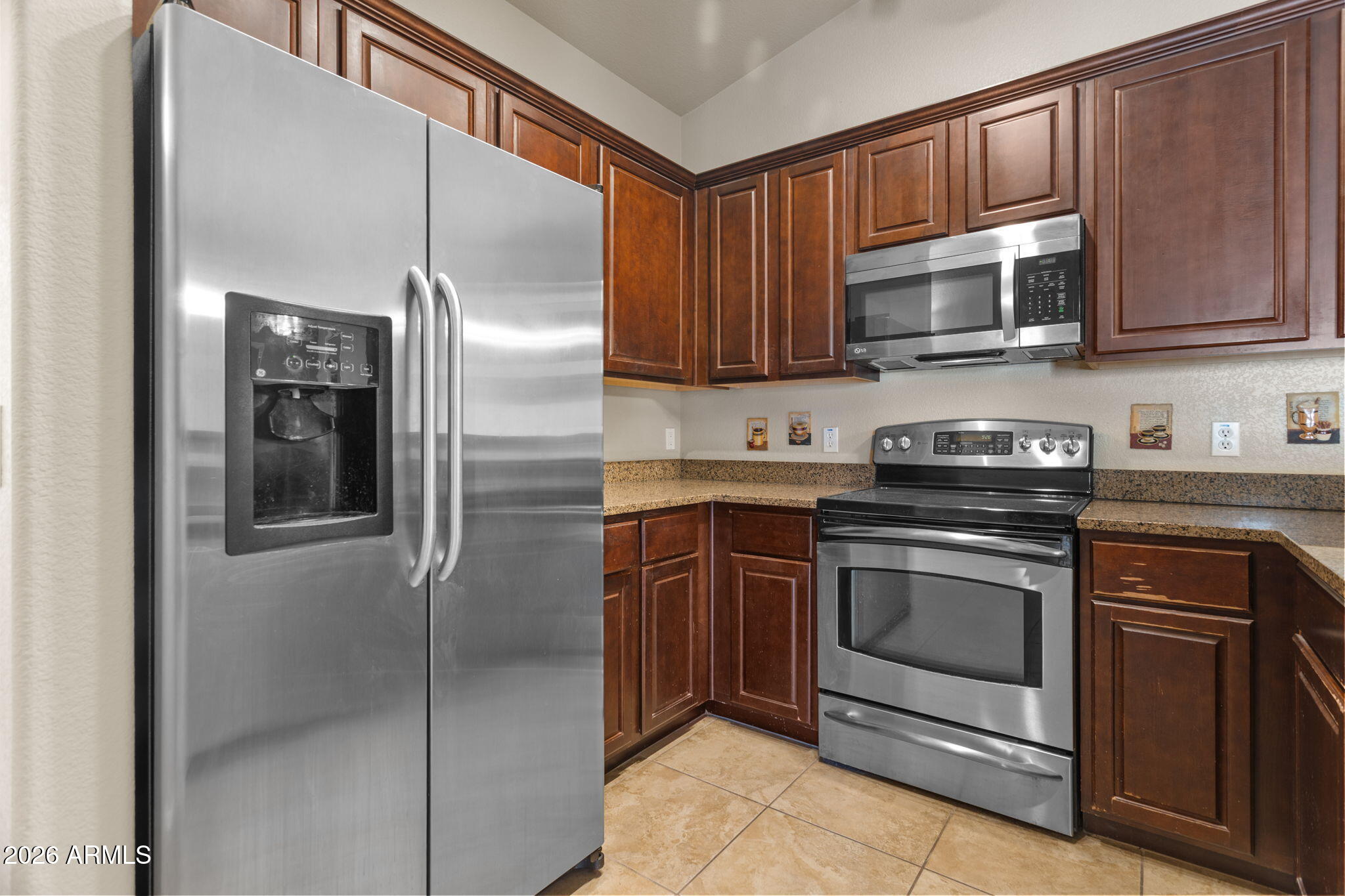 17150 North 23rd Street, Unit 243 Phoenix, AZ 85022 - Photo 14 of 24 a kitchen with stainless steel appliances granite countertop a refrigerator stove and microwave