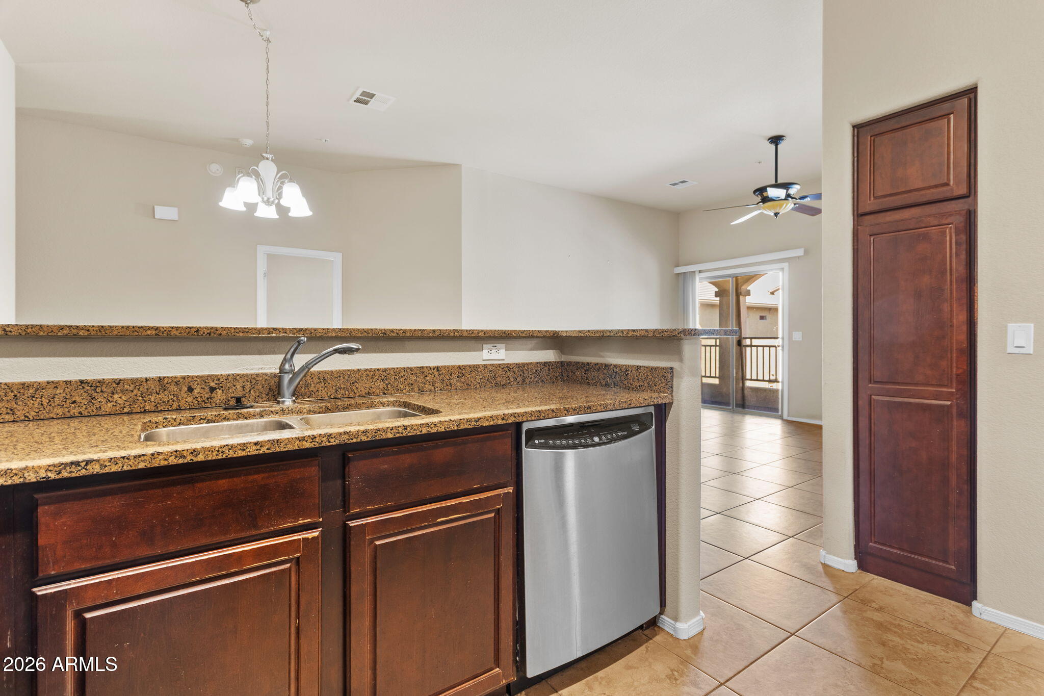 17150 North 23rd Street, Unit 243 Phoenix, AZ 85022 - Photo 16 of 24 a kitchen with stainless steel appliances granite countertop a sink and a refrigerator