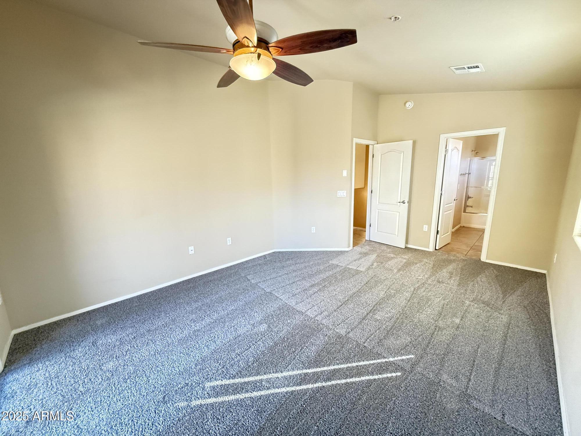17150 North 23rd Street, Unit 243 Phoenix, AZ 85022 - Photo 17 of 36 an empty room with a ceiling fan and a window
