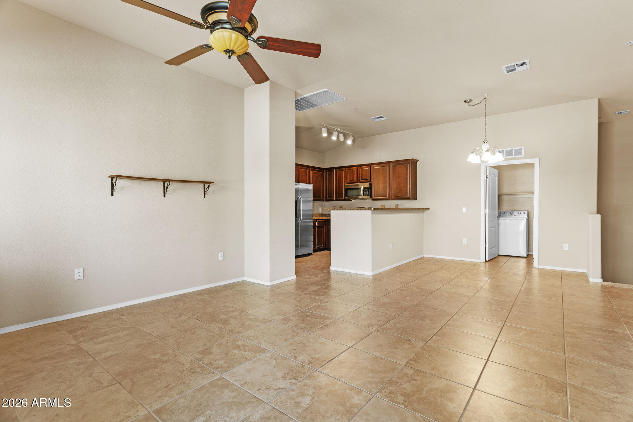 17150 North 23rd Street, Unit 243 Phoenix, AZ 85022 - Photo 19 of 24 a view of a kitchen with a microwave and a refrigerator