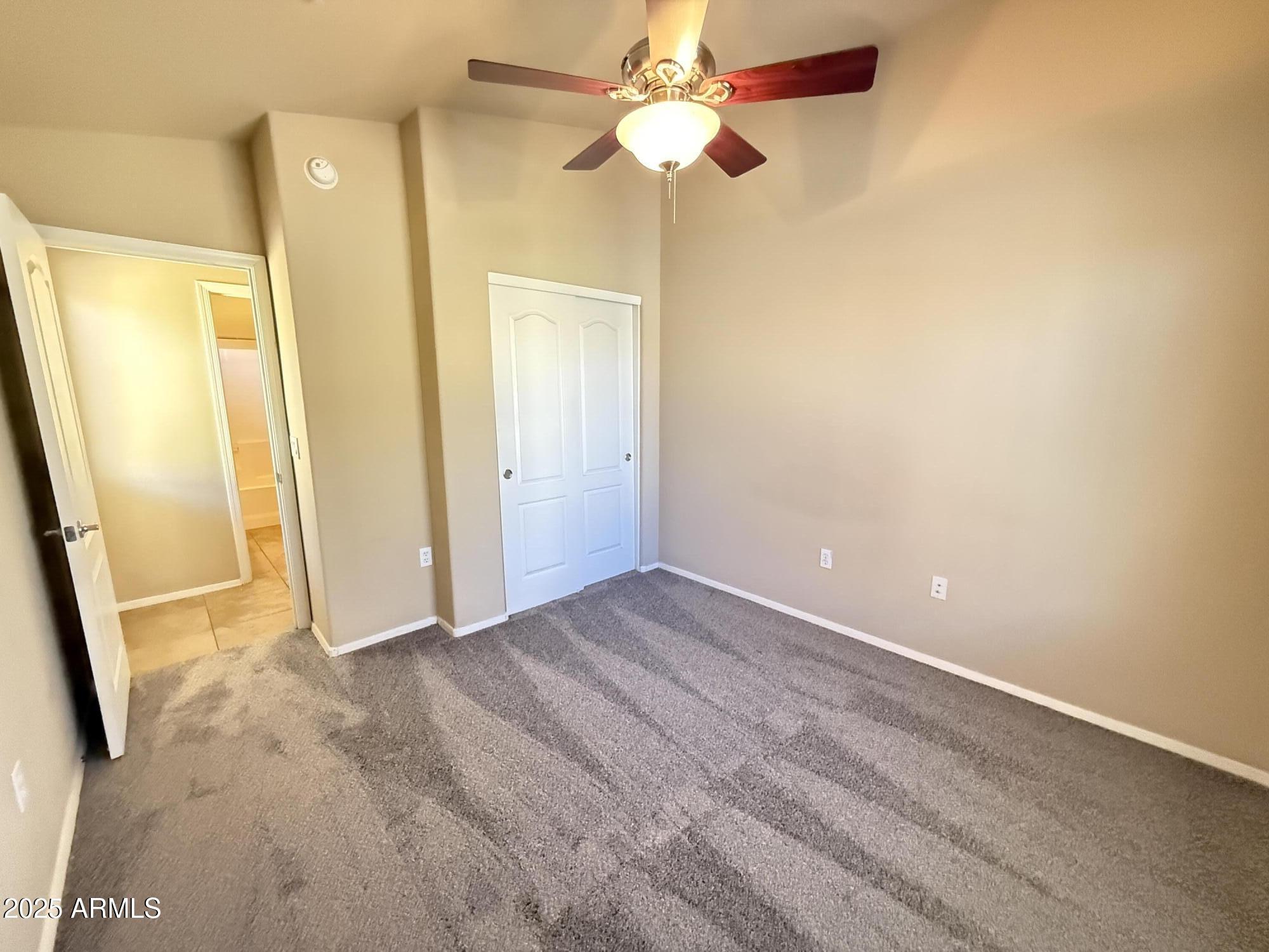 17150 North 23rd Street, Unit 243 Phoenix, AZ 85022 - Photo 26 of 36 a view of a hallway with a chandelier fan and wooden floor