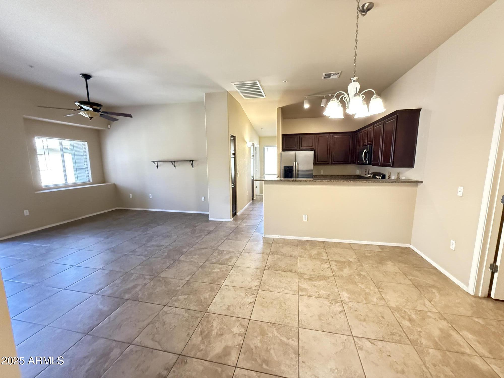 17150 North 23rd Street, Unit 243 Phoenix, AZ 85022 - Photo 5 of 36 a view of a livingroom with a chandelier furniture and windows