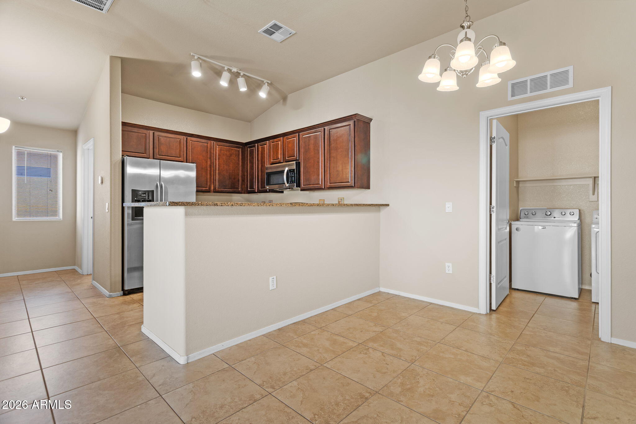 17150 North 23rd Street, Unit 243 Phoenix, AZ 85022 - Photo 9 of 24 a kitchen with stainless steel appliances granite countertop a refrigerator and a sink