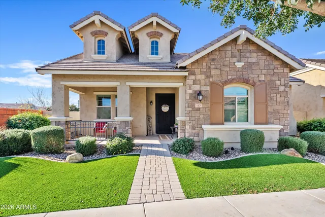 a front view of a house with garden