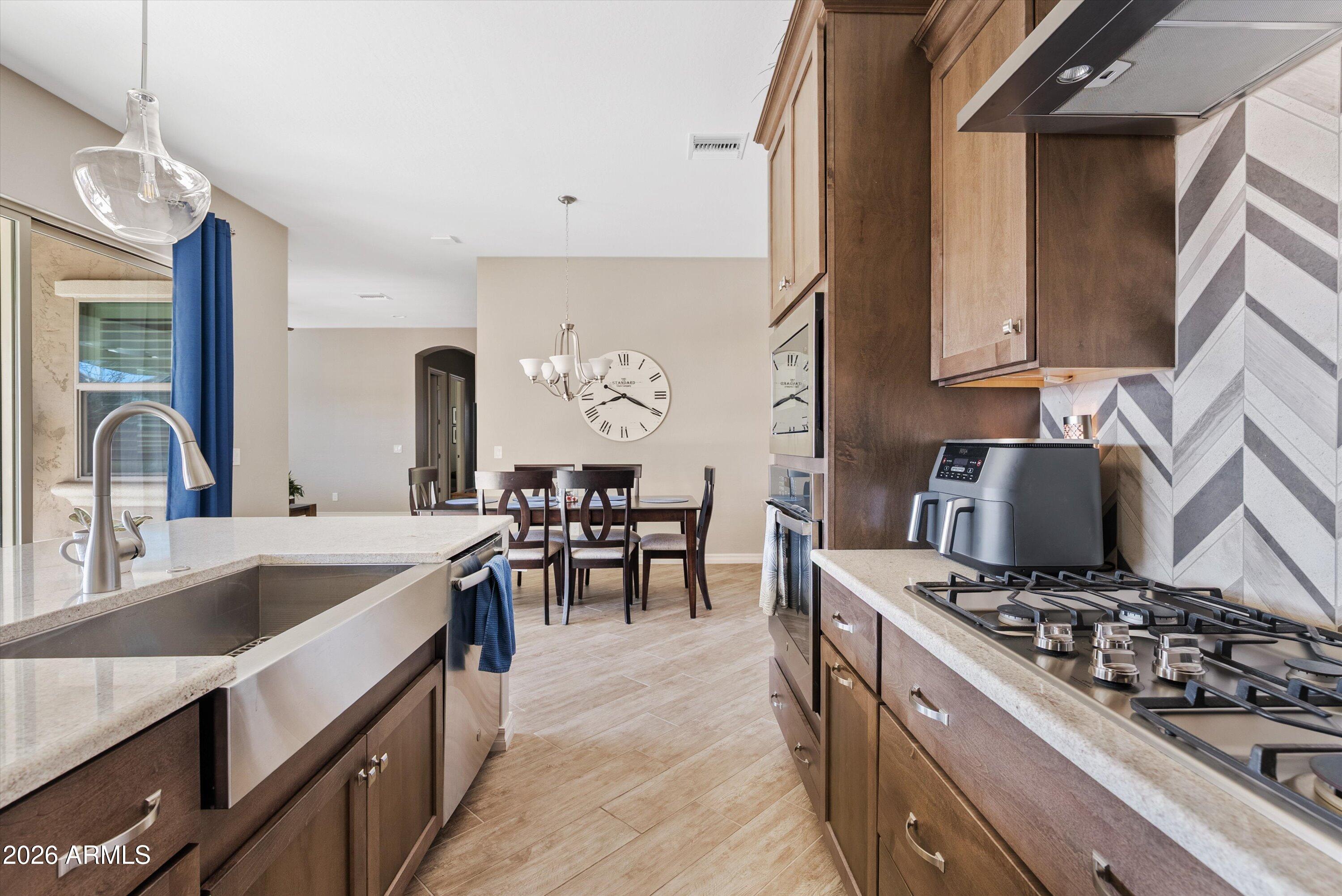 4405 East Dwayne Street Gilbert, AZ 85295 - Photo 16 of 38 a kitchen with stove a sink and cabinets