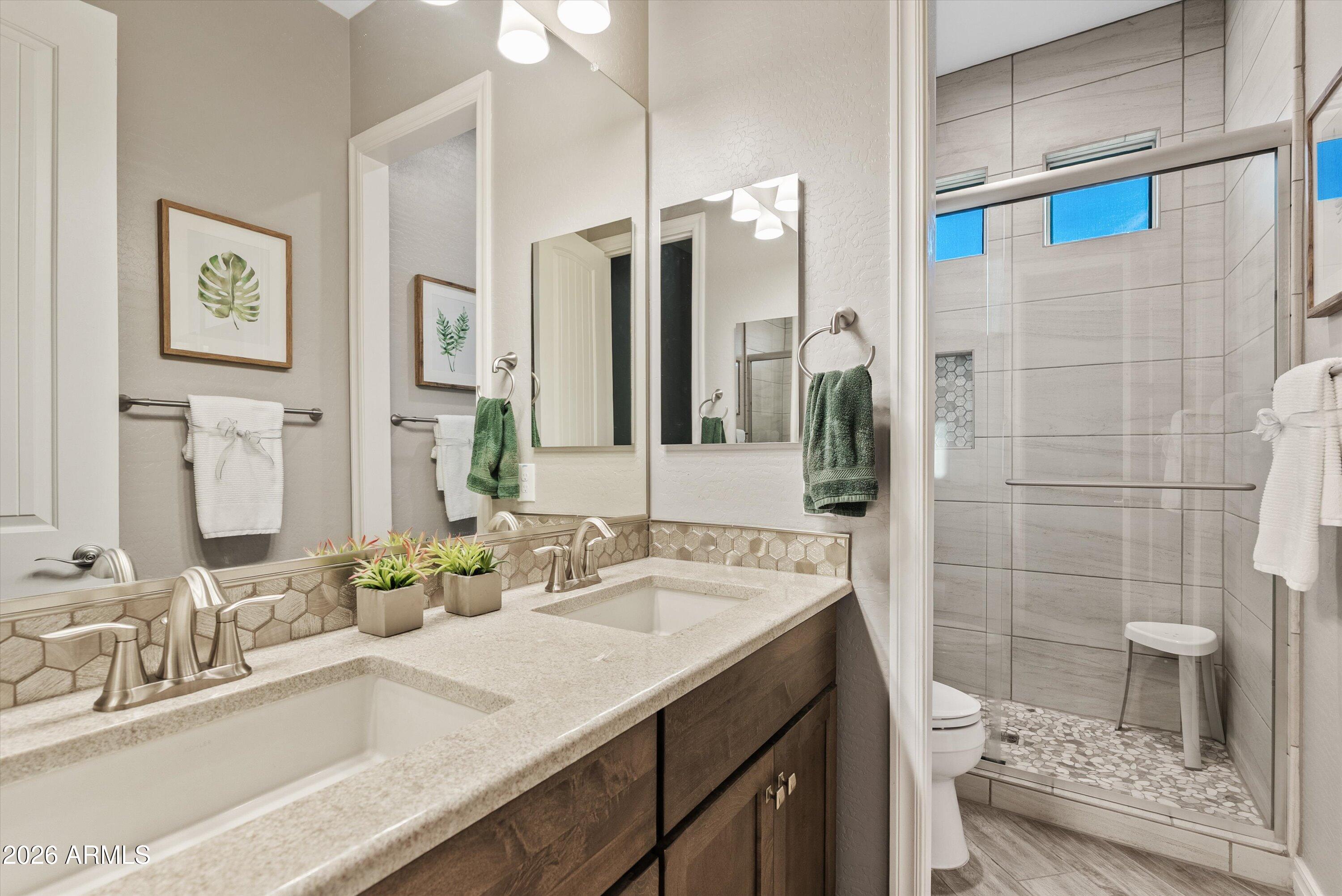 4405 East Dwayne Street Gilbert, AZ 85295 - Photo 25 of 38 a bathroom with a double vanity sink mirror and shower