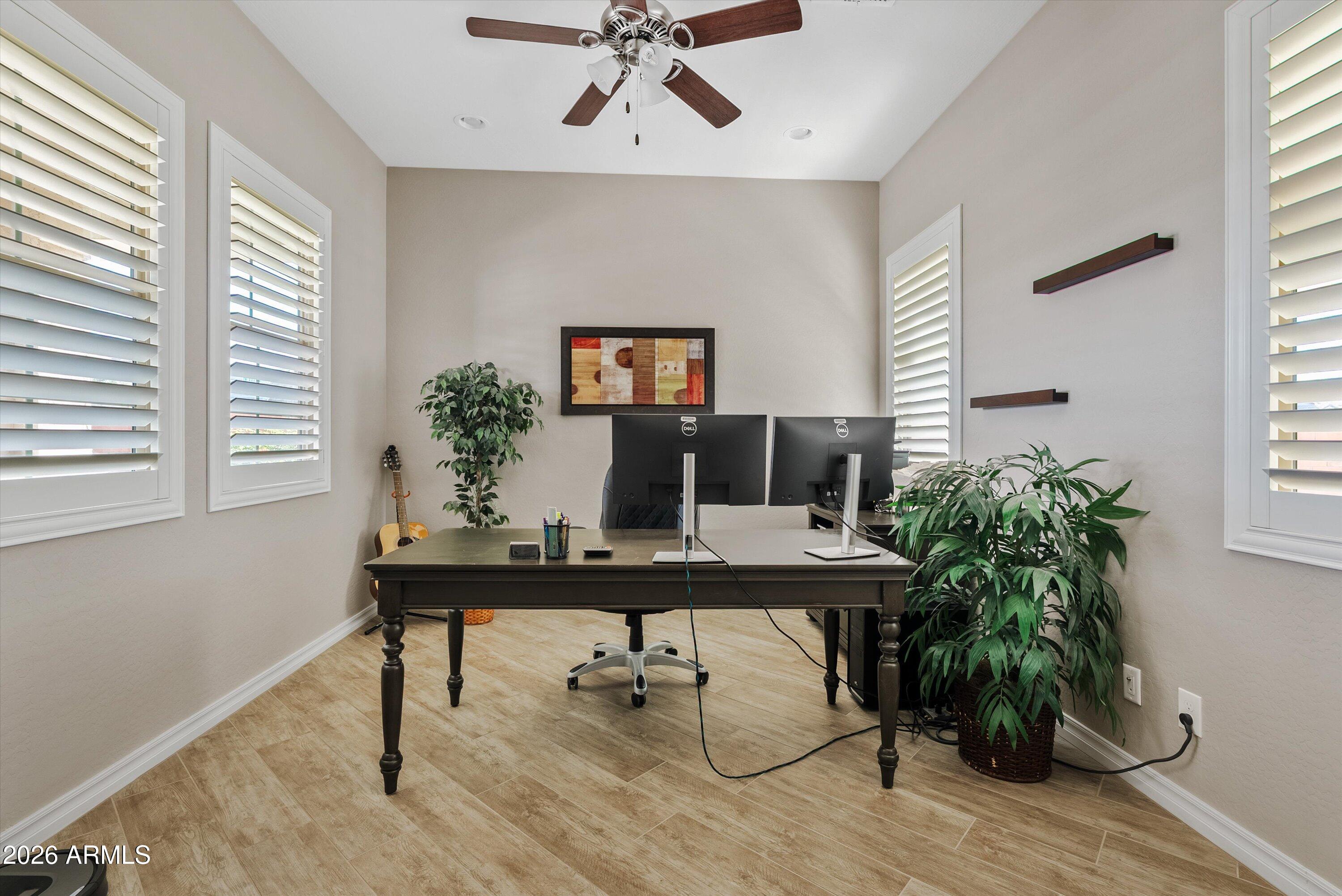 4405 East Dwayne Street Gilbert, AZ 85295 - Photo 2 of 38 a view of a workspace with furniture and a potted plant