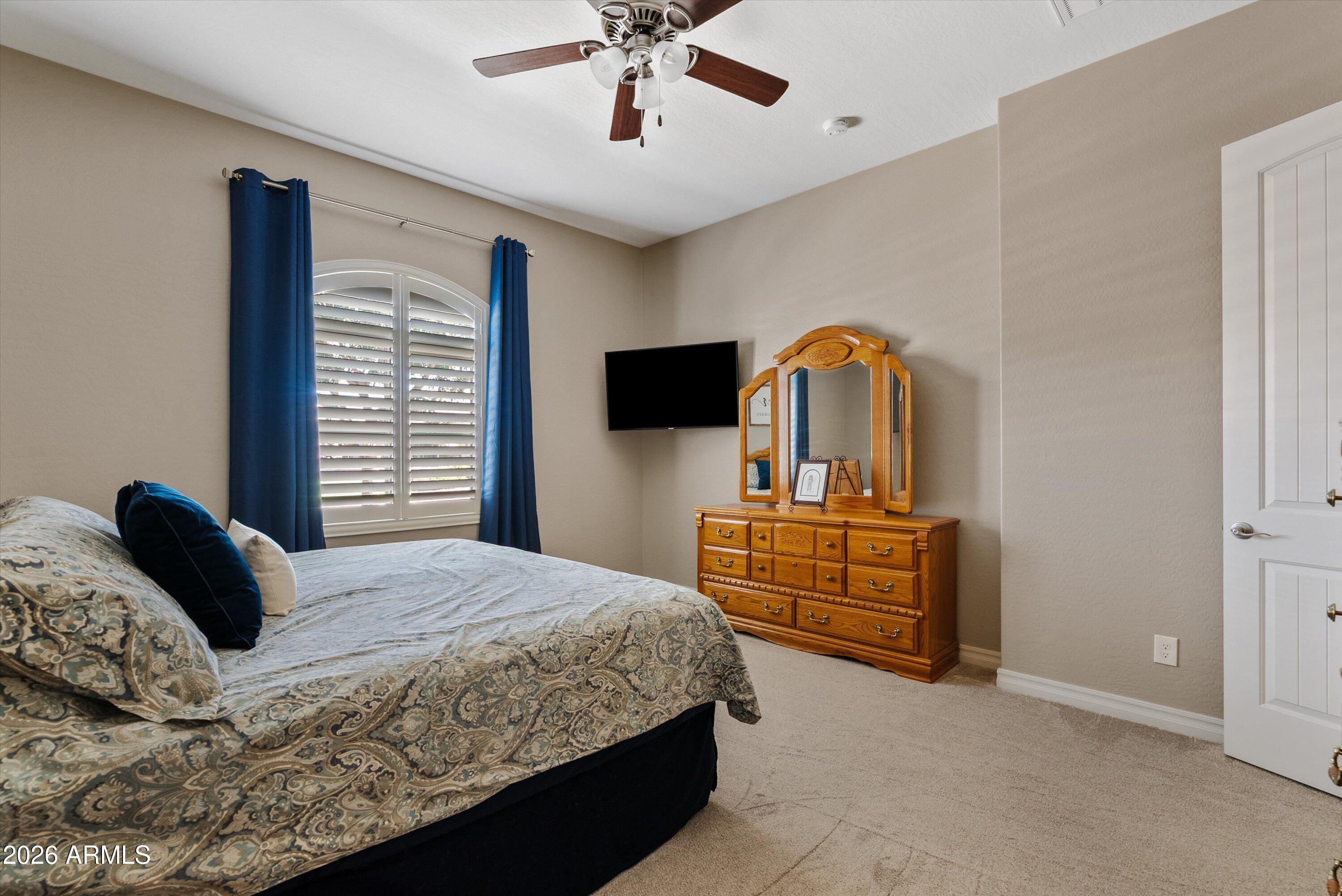 4405 East Dwayne Street Gilbert, AZ 85295 - Photo 8 of 38 a bedroom with a bed and a chandelier