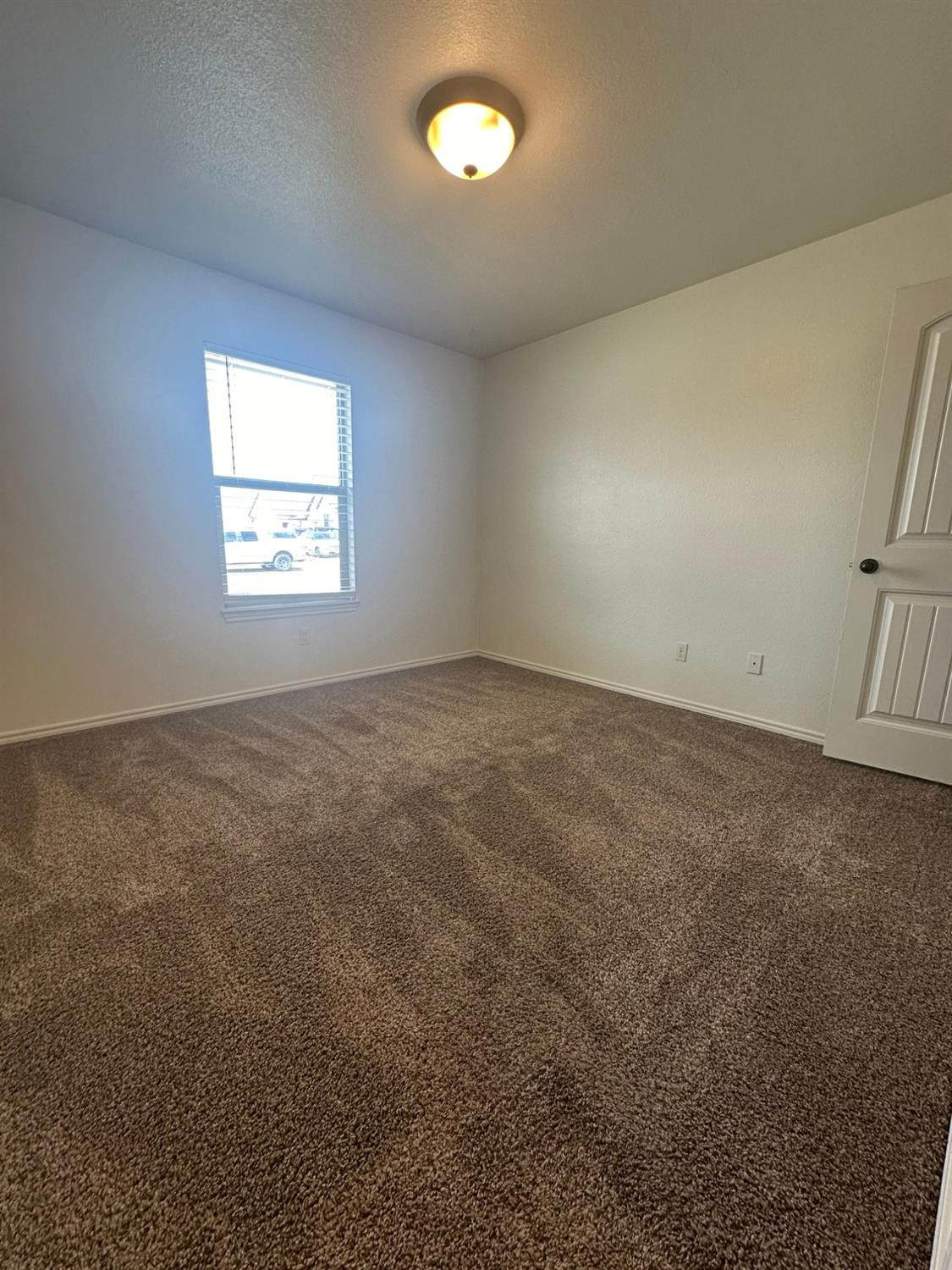 6133 72nd Place, Unit B Lubbock, TX 79424 - Photo 13 of 20 an empty room with a window