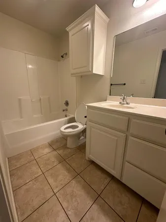 a bathroom with a sink a toilet and mirror