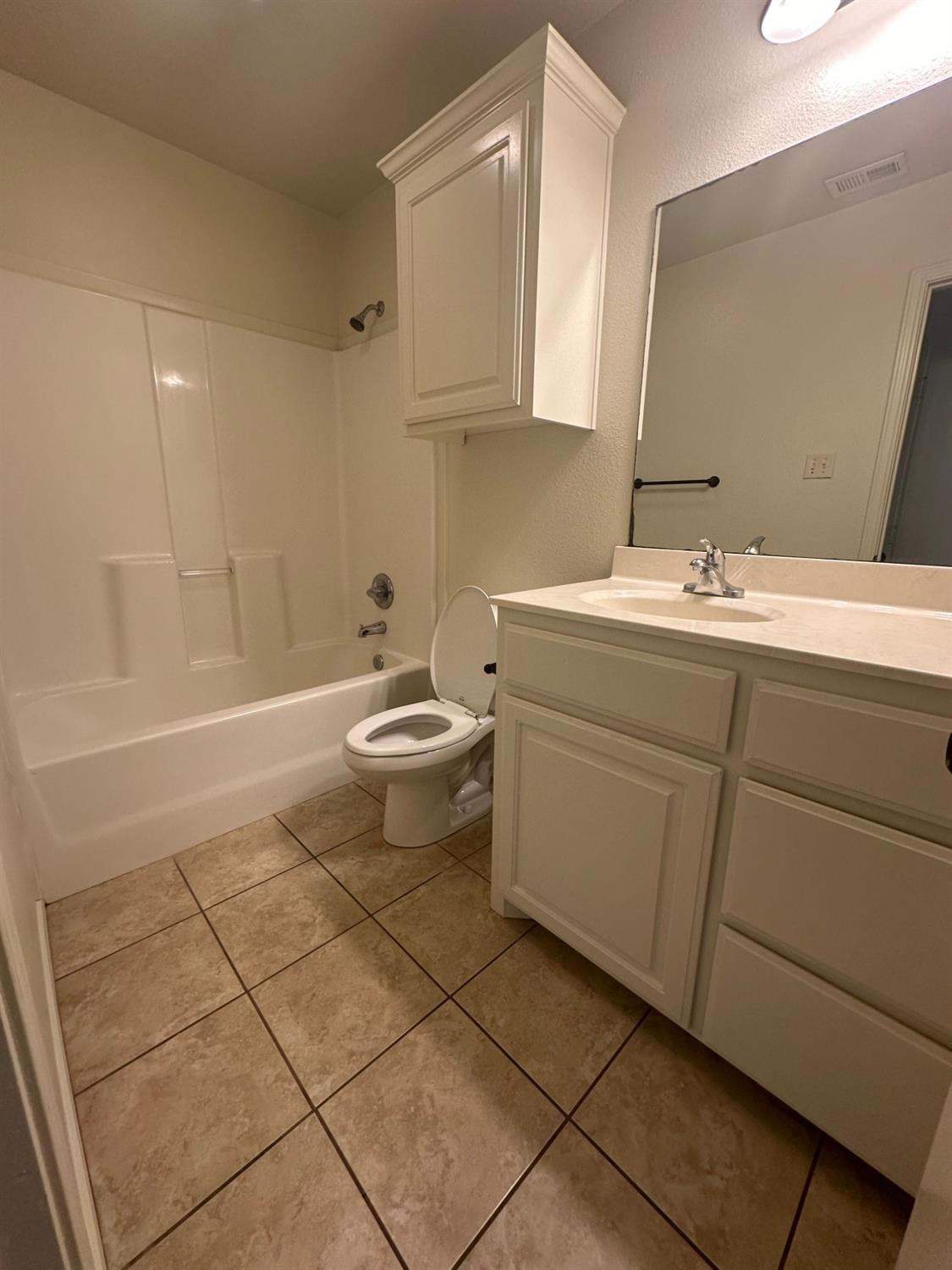 6133 72nd Place, Unit B Lubbock, TX 79424 - Photo 14 of 20 a bathroom with a sink toilet and shower
