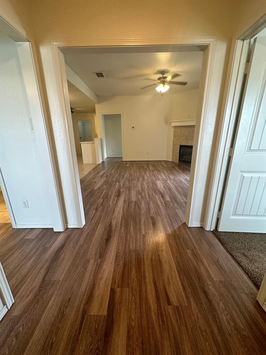 6133 72nd Place, Unit B Lubbock, TX 79424 - Photo 17 of 20 a view of a livingroom with wooden floor and staircase
