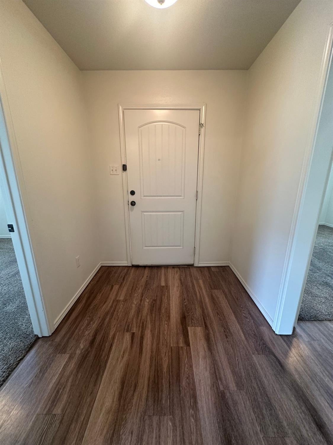 6133 72nd Place, Unit B Lubbock, TX 79424 - Photo 18 of 20 a view of a room with wooden floor