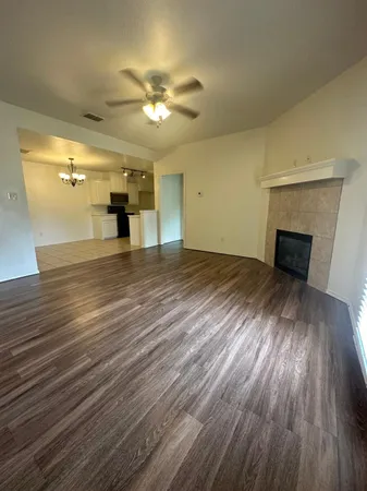 wooden floor in an empty room with a fireplace