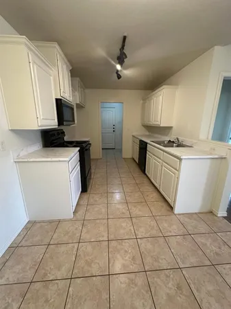 a kitchen with stainless steel appliances granite countertop a sink and a stove