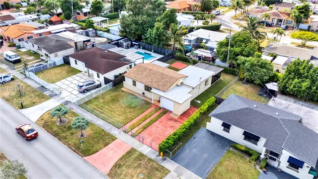 an aerial view of a house with a garden and swimming pool