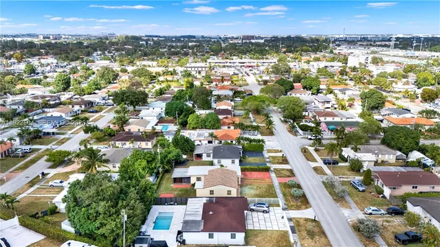 an aerial view of residential houses with outdoor space